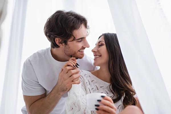 Smiling Woman Holding Blurred Cup Hand Boyfriend Window — Stock Photo, Image