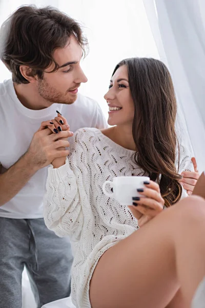 Cheerful Woman Sweater Holding Cup Boyfriend Home — Stock Photo, Image