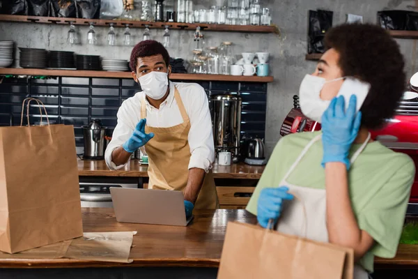 African American Barista Medical Mask Pointing Fingers Colleague Paper Bag — Stock Photo, Image