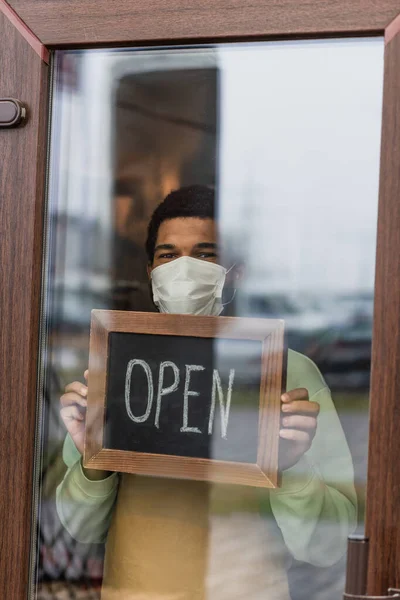 African American Barista Medical Mask Holding Chalkboard Open Lettering Door — Stock Photo, Image