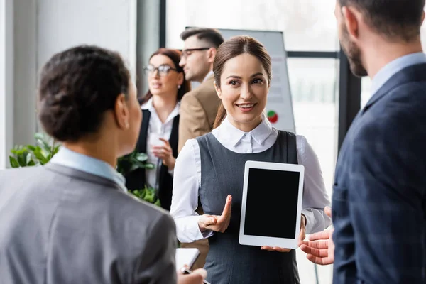 Smiling Businesswoman Holding Digital Tablet Blank Screen Blurred Interracial Colleagues — Stock Photo, Image