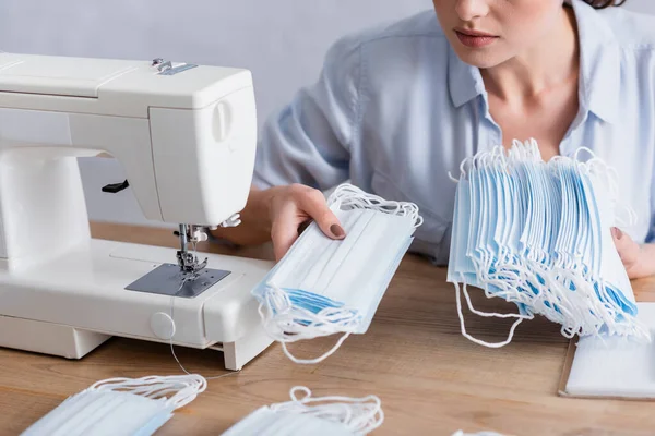 Cropped View Seamstress Holding Medical Masks Notebook Sewing Machine — Stock Photo, Image