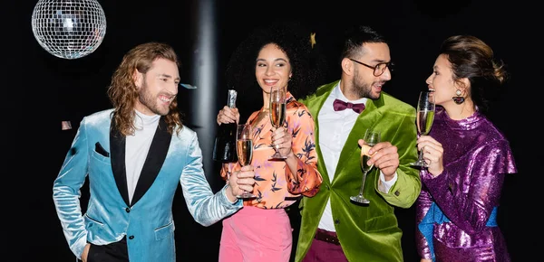 Playful Multiracial Friends Standing Glasses Champagne Black Background Banner — Stock Photo, Image