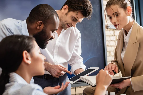 Business Colleagues Pointing Digital Tablet Notebook Meeting — Stock Photo, Image