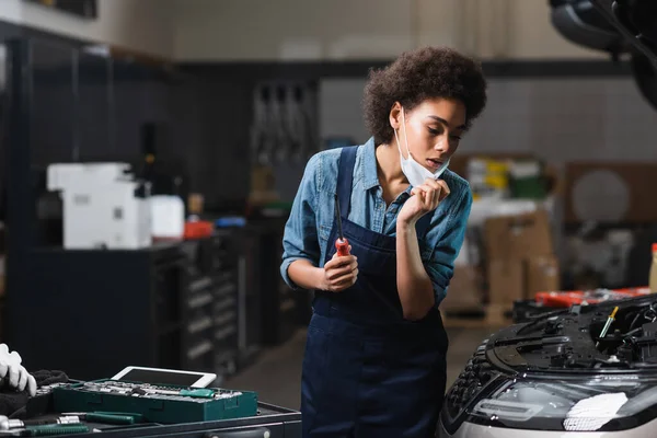 Young African American Mechanic Holding Protective Mask Hand While Working — Stock Photo, Image