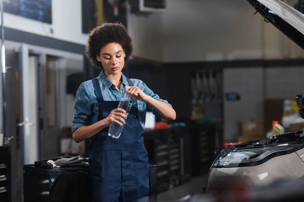 Young African American Mechanic Opening Bottle Water Car Garage — Stock Photo, Image