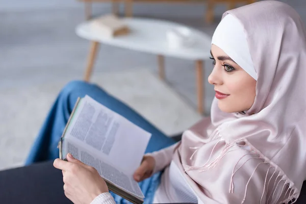 Dreamy Muslim Woman Looking Away While Sitting Book Home — Stock Photo, Image