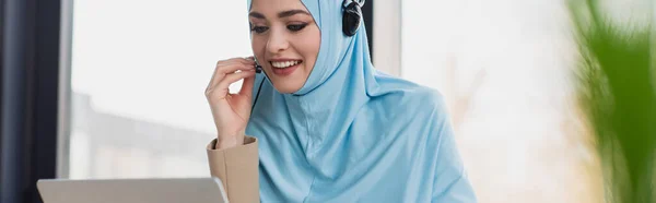 Cheerful Muslim Woman Adjusting Headset While Working Call Center Banner — Stock Photo, Image