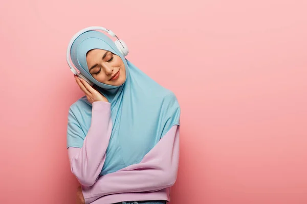 Pleased Muslim Woman Listening Music Headphones Closed Eyes Pink Background — Stock Photo, Image