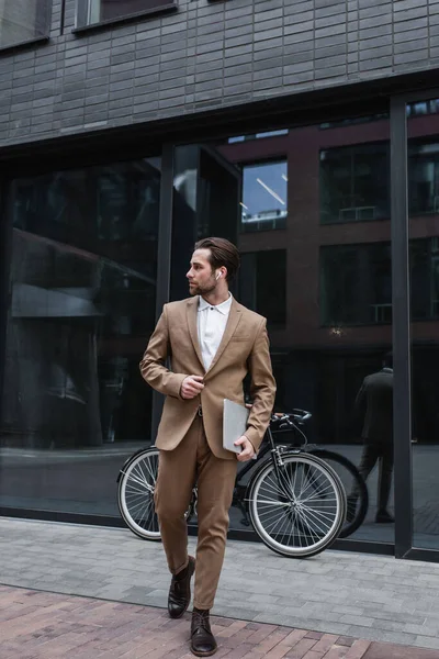 Full Length Happy Businessman Earphones Walking Holding Laptop Building Bike — Stock Photo, Image