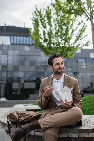 Pleased Businessman Suit Eating Asian Food While Holding Chopsticks — Stock Photo, Image