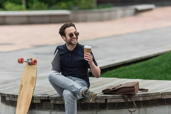 Happy Man Sunglasses Polo Shirt Holding Laptop Paper Cup Longboard — Stock Photo, Image