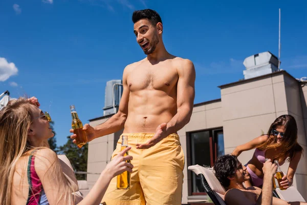 Positive Muslim Man Beer Talking Friend Swimwear Outdoors — Stock Photo, Image