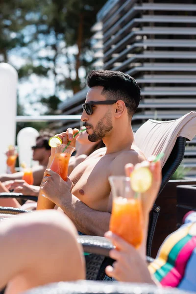 Arabian Man Sunglasses Drinking Cocktail Blurred Friend Swimsuit — Stock Photo, Image