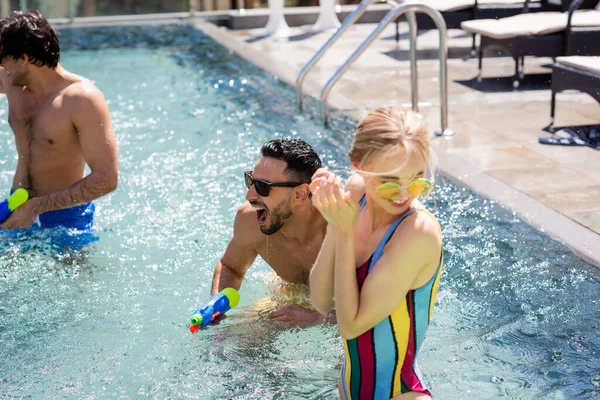Cheerful Multiethnic Friends Fighting Water Pistols Swimming Pool — Stock Photo, Image