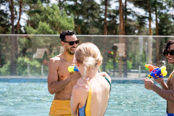 Excited Muslim Man Multiethnic Friends Playing Water Guns Swimming Pool — Stock Photo, Image