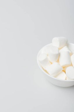 high angle view of soft and puffy marshmallows in bowl on white clipart