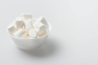 soft and puffy marshmallows in bowl on white clipart