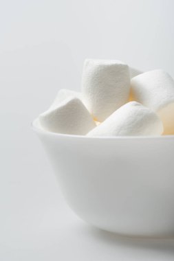 soft and chewy marshmallows in bowl on white clipart