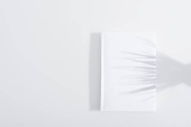 shadow on hardcover of book on white background clipart