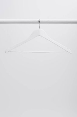 white hanger on clothing rack isolated on gray clipart