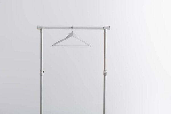 white hanger on garment rack isolated on grey