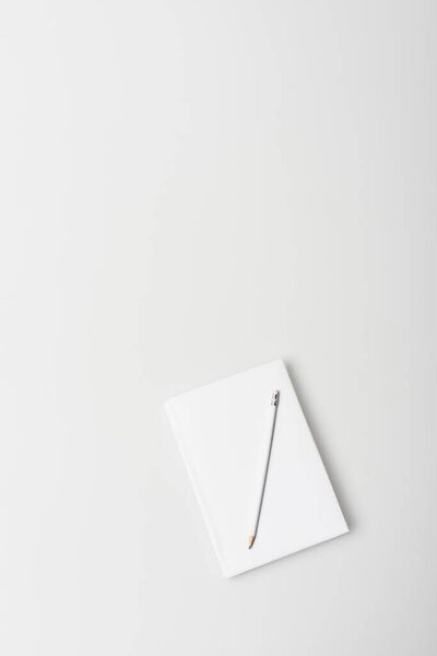 top view of notebook in hardcover with pencil isolated on white 