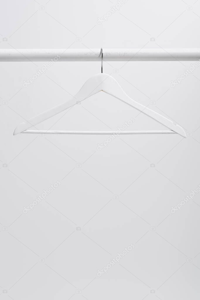white hanger on clothing rack isolated on gray