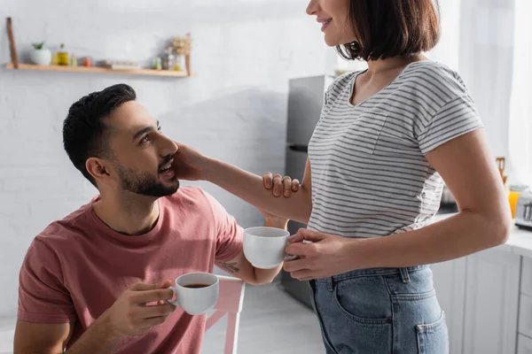 Young Couple Gently Touching Each Other Holding Cups Coffee Kitchen — Stock Photo, Image