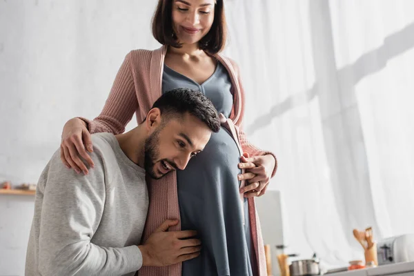Young Man Gently Hugging Pregnant Woman Holding Head Belly Kitchen — Stock Photo, Image