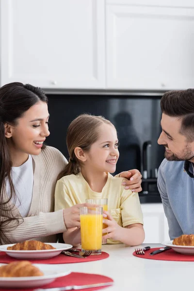 Happy Woman Embracing Daughter Breakfast Smiling Husband Kitchen — Stock Photo, Image