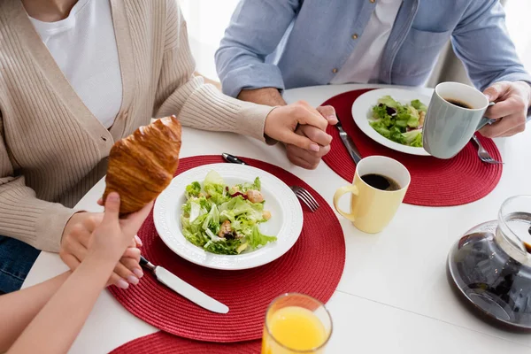 Cropped View Girl Holding Croissant Parents Fresh Vegetable Salad — Stock Photo, Image