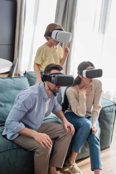 Astonished Girl Pointing Finger While Gaming Together Surprised Parents — Stock Photo, Image