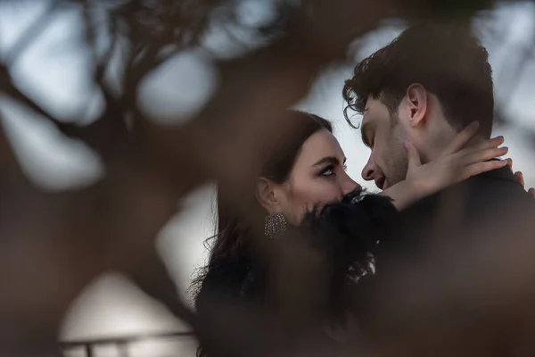 Woman Faux Fur Jacket Hugging Man Blurred Foreground — Stock Photo, Image