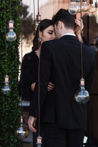 Elegant Woman Hugging Man Light Bulbs Terrace — Stock Photo, Image