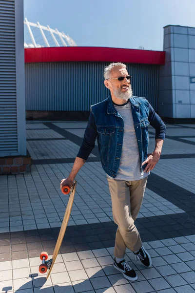 Full Length Happy Middle Aged Man Sunglasses Holding Longboard Standing — Foto Stock