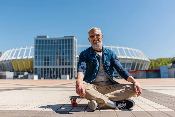 Cheerful Middle Aged Man Sunglasses Sitting Longboard — Stock Photo, Image