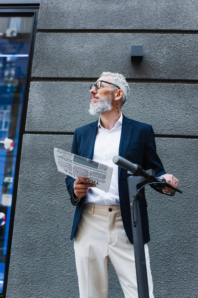Low Angle View Mature Businessman Blazer Holding Newspaper Scooter — Zdjęcie stockowe