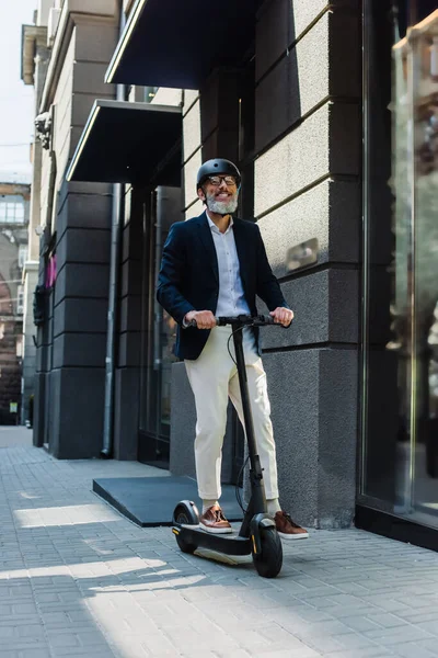Full Length Happy Mature Businessman Blazer Helmet Riding Scooter — Fotografia de Stock