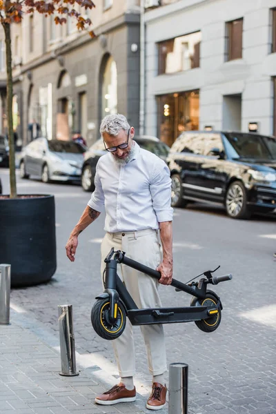 Bearded Middle Aged Man White Shirt Carrying Electric Scooter Street — Stock Photo, Image