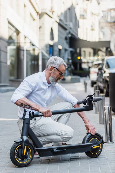 Mature Man Adjusting Electric Scooter Street — Stock Photo, Image