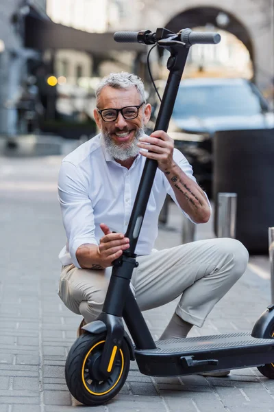Happy Mature Man Adjusting Electric Scooter Street — Stock Fotó