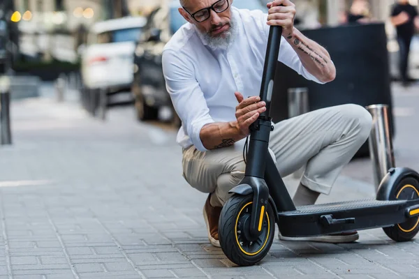 Mature Man Glasses Shirt Adjusting Electric Scooter Street — Zdjęcie stockowe