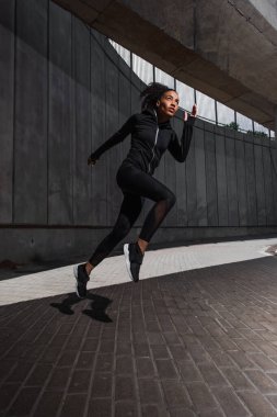 African american runner training near building on urban street  clipart