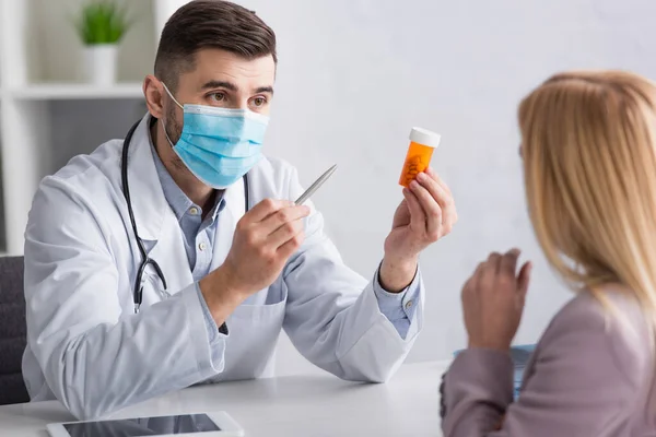 Blurred Woman Doctor Medical Mask Pointing Container Pills — Stock Photo, Image