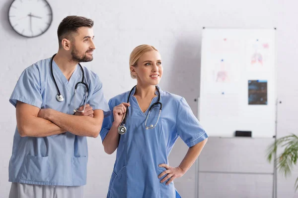 Physicians Wearing Blue Uniform Stethoscopes Looking Away Hospital — Stock Photo, Image