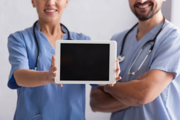 Cropped View Smiling Physician Showing Digital Tablet Colleague Crossed Arms — Stock Photo, Image