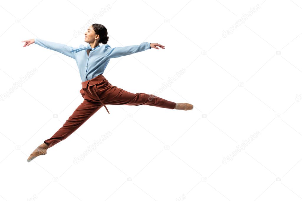 Side view of cheerful ballerina jumping isolated on white 