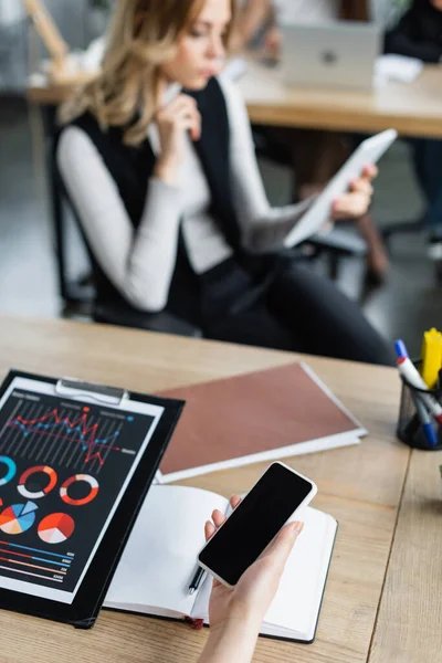 Blurred Businesswoman Using Digital Tablet Colleague Smartphone Charts — Stock Photo, Image