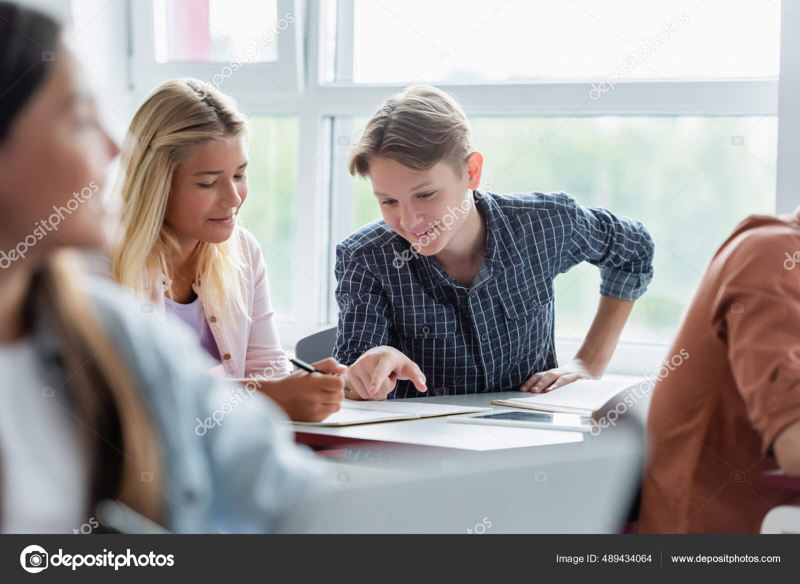 Smiling Schoolboy Pointing Notebook Friend Classroom — Stock Photo ...